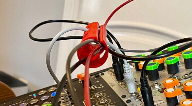 A CablePortal keeping a modular synth tidy. CablePortals make it easy to route Eurorack patch cables across your modular synth by keeping patch cables out of your way.
